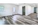 Open-concept living room with new vinyl flooring, connecting multiple rooms at 4502 Florence St, Apopka, FL 32712