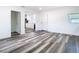 An open-concept living room with vinyl floors and neutral walls, leading to a modern kitchen at 4502 Florence St, Apopka, FL 32712