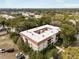 Aerial view of a building surrounded by lush trees in a picturesque neighborhood at 535 N Interlachen Ave # 106, Winter Park, FL 32789