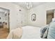 Modern bedroom with white bedding, hard wood floors, closet space and an eye-catching light fixture at 535 N Interlachen Ave # 106, Winter Park, FL 32789