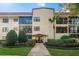 Beautiful condo complex with a red tile roof and well-maintained landscaping at 535 N Interlachen Ave # 106, Winter Park, FL 32789