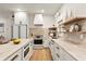 Bright kitchen featuring stainless steel appliances, marble countertops, tile backsplash and wooden floors at 535 N Interlachen Ave # 106, Winter Park, FL 32789