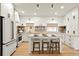 Bright kitchen with white cabinetry, stainless steel appliances, and a center island with barstool seating at 535 N Interlachen Ave # 106, Winter Park, FL 32789