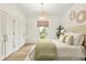 Bright main bedroom with hardwood floors, ample closet space, and a view to the exterior at 535 N Interlachen Ave # 106, Winter Park, FL 32789
