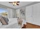 This bedroom features hardwood floors, a ceiling fan, and double French doors at 620 Park Lake St, Orlando, FL 32803