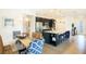 Modern kitchen featuring black cabinetry, stainless steel appliances, granite counters, and tile floors at 6552 Rhythm Dr, Mascotte, FL 34753
