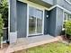 Back patio with gray paint and sliding glass doors leading to the home's interior at 6640 S Goldenrod Rd # 118B, Orlando, FL 32822