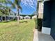 Lush backyard with green grass and palm tree between rows of townhomes at 6640 S Goldenrod Rd # 118B, Orlando, FL 32822