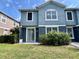 Exterior rear view of home with sliding glass doors, lawn, and lush landscaping at 6640 S Goldenrod Rd # 118B, Orlando, FL 32822