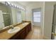 Well-lit bathroom with dual sinks and a glass-enclosed shower at 6640 S Goldenrod Rd # 118B, Orlando, FL 32822