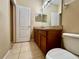 This bathroom is equipped with a toilet, vanity, and medicine cabinet for convenience at 6640 S Goldenrod Rd # 118B, Orlando, FL 32822