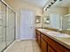 This bathroom features a double sink vanity, neutral tones, and a tiled walk-in shower with a glass enclosure at 6640 S Goldenrod Rd # 118B, Orlando, FL 32822