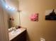 Cozy bathroom featuring a single sink vanity, light fixtures, and a mirror enhancing the overall aesthetic at 6640 S Goldenrod Rd # 118B, Orlando, FL 32822