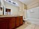 This bathroom is equipped with a bathtub and shower combo, vanity, and medicine cabinet for convenience at 6640 S Goldenrod Rd # 118B, Orlando, FL 32822