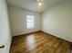 Empty bedroom with wood-look flooring, a ceiling fan, and a window providing natural light at 6640 S Goldenrod Rd # 118B, Orlando, FL 32822
