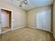 This bedroom offers carpeting, a fan, and a double-door closet for convenient storage at 6640 S Goldenrod Rd # 118B, Orlando, FL 32822