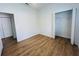 Clean bedroom featuring wood floors and a spacious closet at 6640 S Goldenrod Rd # 118B, Orlando, FL 32822