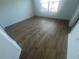 Bright bedroom with wood floors and a window at 6640 S Goldenrod Rd # 118B, Orlando, FL 32822