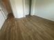 Cozy bedroom showcasing neutral wood flooring, white trim and a walk-in closet at 6640 S Goldenrod Rd # 118B, Orlando, FL 32822