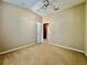This bedroom offers neutral walls, carpeting, and a doorway leading to another room in the home at 6640 S Goldenrod Rd # 118B, Orlando, FL 32822