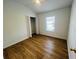 Bright bedroom featuring wood floors, a ceiling fan, and a spacious closet at 6640 S Goldenrod Rd # 118B, Orlando, FL 32822