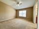 Bedroom with neutral carpeting, a ceiling fan, and a window offering natural light at 6640 S Goldenrod Rd # 118B, Orlando, FL 32822
