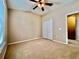 This bedroom offers carpeting, a ceiling fan, and a double-door closet for convenient storage at 6640 S Goldenrod Rd # 118B, Orlando, FL 32822
