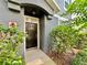 Home's front door area with clean landscaping and a black entry door at 6640 S Goldenrod Rd # 118B, Orlando, FL 32822