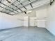 Spacious garage with epoxy flooring, storage shelves and an automatic door opener at 6640 S Goldenrod Rd # 118B, Orlando, FL 32822
