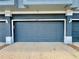 Attached garage with blue door and white trim; address number 6640 is clearly displayed at 6640 S Goldenrod Rd # 118B, Orlando, FL 32822