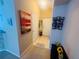 Inviting hallway with art, tiled flooring, and an organized coat rack enhancing the home's functionality at 6640 S Goldenrod Rd # 118B, Orlando, FL 32822