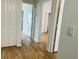 Hallway with wood-look floors, white walls, and several doorways leading to other rooms at 6640 S Goldenrod Rd # 118B, Orlando, FL 32822