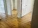 Open hallway with wood-look flooring and multiple doorways, creating a sense of flow at 6640 S Goldenrod Rd # 118B, Orlando, FL 32822