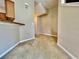 Hallway area featuring neutral colored walls and carpet, along with white baseboards at 6640 S Goldenrod Rd # 118B, Orlando, FL 32822