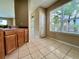 Kitchen area featuring wood cabinets, laminate counters, and a bright window at 6640 S Goldenrod Rd # 118B, Orlando, FL 32822