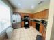 Bright kitchen boasts stainless steel appliances, wooden cabinets, and ample counter space for cooking at 6640 S Goldenrod Rd # 118B, Orlando, FL 32822
