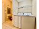 Laundry area features a washer and dryer with tile floors and overhead wire shelving at 6640 S Goldenrod Rd # 118B, Orlando, FL 32822
