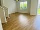 Sun-filled living room with luxury vinyl plank flooring and a sliding glass door to the backyard at 6640 S Goldenrod Rd # 118B, Orlando, FL 32822