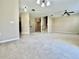 Open-concept living room with stairs, carpet, and tile entry to the kitchen at 6640 S Goldenrod Rd # 118B, Orlando, FL 32822