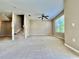 Spacious living room with carpet, stairs, and bright window with blinds at 6640 S Goldenrod Rd # 118B, Orlando, FL 32822
