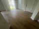 Bright living room with wood flooring, white walls, and sliding glass doors to let in natural light at 6640 S Goldenrod Rd # 118B, Orlando, FL 32822
