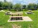 A vibrant green space with several picnic tables, offering a perfect spot for outdoor gatherings at 6640 S Goldenrod Rd # 118B, Orlando, FL 32822