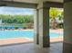 A view of the pool featuring a fountain, lounge chairs, and lush green trees at 6640 S Goldenrod Rd # 118B, Orlando, FL 32822