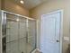 This bathroom features a glass enclosed walk-in shower and a door leading to another area of the home at 6640 S Goldenrod Rd # 118B, Orlando, FL 32822