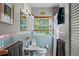 Cozy bathroom with a window, cabinet mirror, and pink and blue tile at 767 Baffie Ave, Winter Park, FL 32789