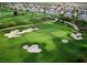 Lush green golf course with sand traps and residential homes in a well-kept community at 7691 Heritage Crossing Way # C-1, Reunion, FL 34747