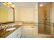 Bathroom with a large mirror, soaking tub and glass-enclosed shower at 7691 Heritage Crossing Way # C-1, Reunion, FL 34747