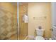 Tiled shower with glass door, complementing the well-maintained bathroom with modern fixtures at 7691 Heritage Crossing Way # C-1, Reunion, FL 34747