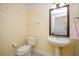 Cozy powder room featuring a pedestal sink, and a decorative mirror at 7691 Heritage Crossing Way # C-1, Reunion, FL 34747