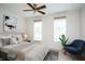Bright bedroom with a large bed, a ceiling fan and two windows at 7691 Heritage Crossing Way # C-1, Reunion, FL 34747